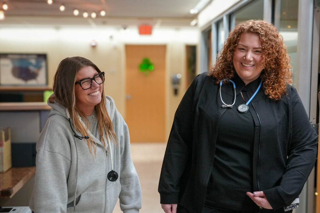 Tiffany Richmond, right, laughs with Laura Sweeney, co-assistant manager of medical assistants, at The Wright Center for Community Health Mid Valley